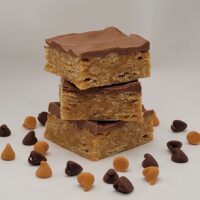 Scotcheroos, featuring crispy rice cereal mixed with a chewy peanut butter base, topped with a smooth chocolate -butterscotch layer. These handmade, no-bake treats are perfect for sweet lovers, gifting, and indulging in a nostalgic dessert experience
