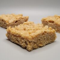Close-up of a soft and chewy peanut butter bar with a smooth golden texture, easy no-bake dessert made with pantry ingredients, gluten-free peanut butter snack bar for kids and adults, high-protein sweet treat for lunchboxes, parties, or on-the-go snacking.
