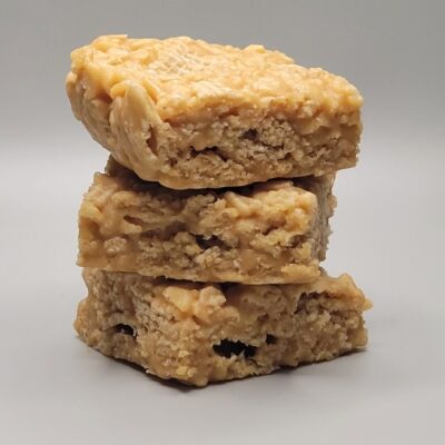 Stack of chewy peanut butter bars made with crispy rice Chex cereal and a gooey peanut butter mixture, easy no-bake snack bars for kids, gluten-free peanut butter dessert recipe, crunchy cereal treat for lunchboxes, parties, and quick sweet cravings.