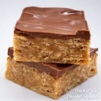 Close-up of thick homemade Scotcheroo bars showing chewy peanut butter rice crispy texture with chocolate and butterscotch topping