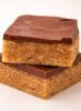 Stacked Scotcheroo bars with thick chocolate and butterscotch topping over chewy peanut butter cereal base {{brizy_dc_image_alt imageSrc=