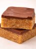 Stacked Scotcheroo bars with thick chocolate and butterscotch topping over chewy peanut butter cereal base